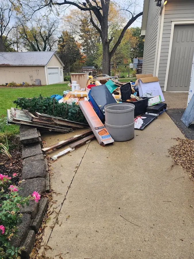 Dumpster being loaded with debris for Residential Dumpster Rental in Boone